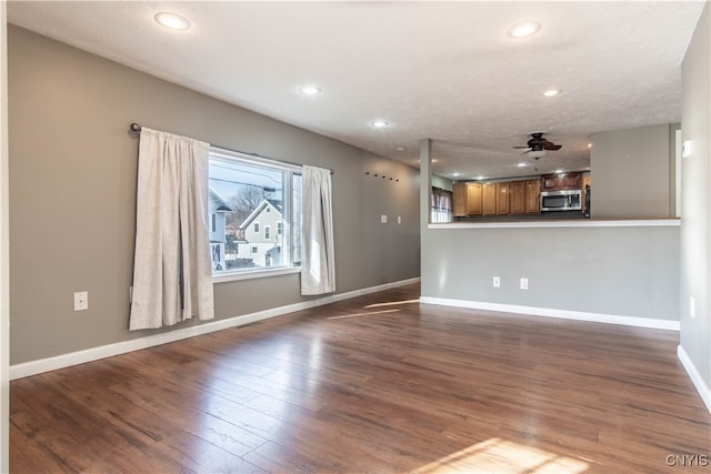 unfurnished living room with hardwood / wood-style floors and ceiling fan