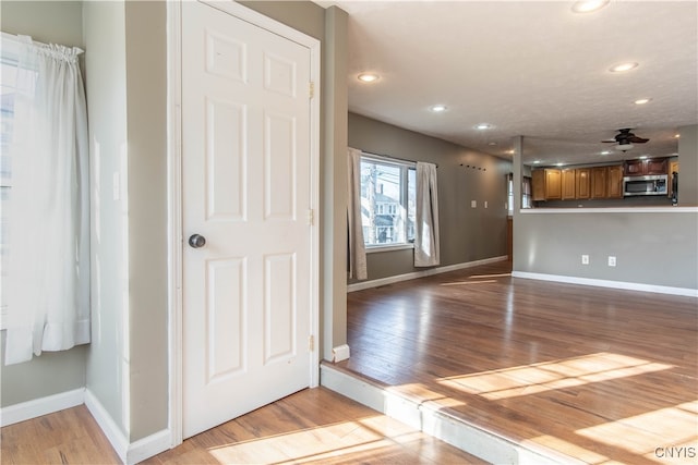 interior space featuring light wood-type flooring and ceiling fan