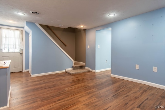 interior space with wood-type flooring and a textured ceiling