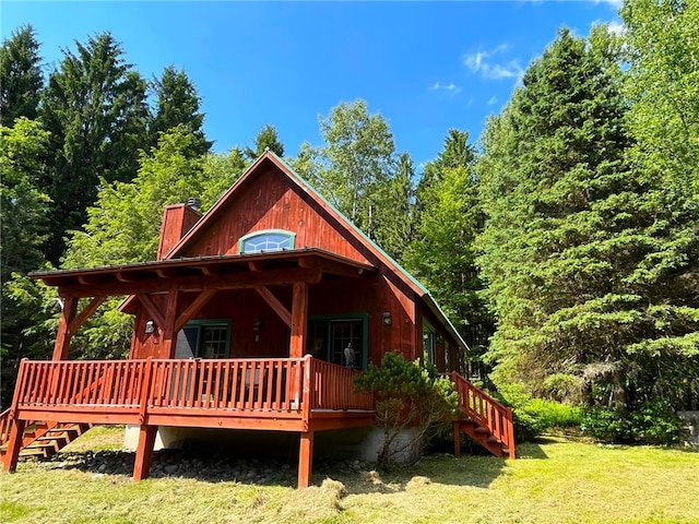 exterior space featuring a lawn and a deck