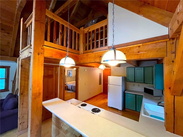 kitchen with sink, vaulted ceiling with beams, white refrigerator, light hardwood / wood-style floors, and pendant lighting