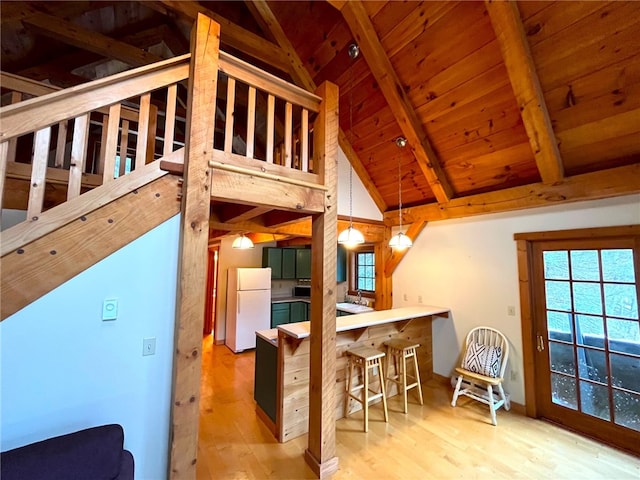 kitchen featuring wooden ceiling, white refrigerator, hanging light fixtures, beamed ceiling, and light hardwood / wood-style floors