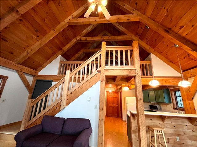 living room featuring beam ceiling, wood ceiling, and light hardwood / wood-style flooring