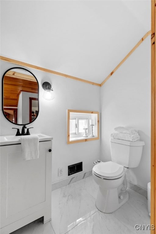 bathroom featuring crown molding, vanity, and toilet