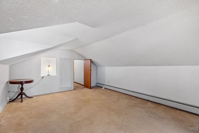 bonus room with a textured ceiling, light colored carpet, baseboard heating, and vaulted ceiling