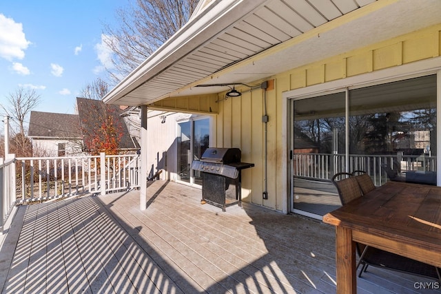 wooden terrace featuring a grill