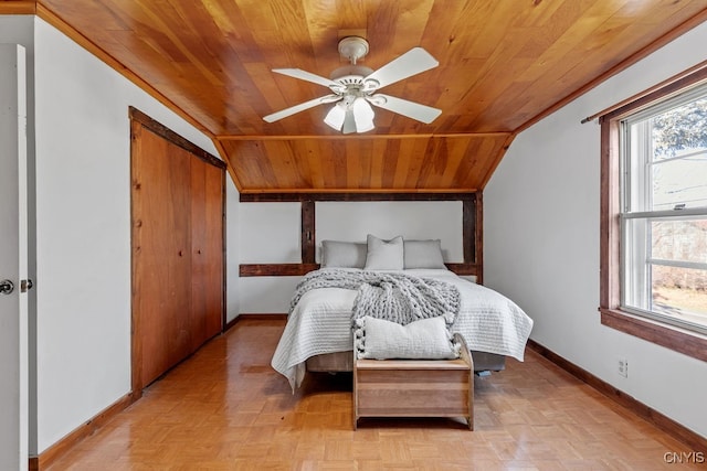 bedroom with ceiling fan, wooden ceiling, light parquet flooring, a closet, and lofted ceiling