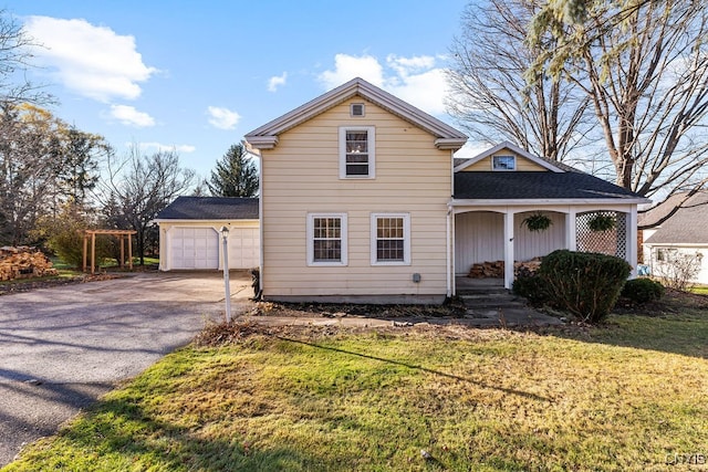 front of property featuring a porch, a garage, and a front lawn