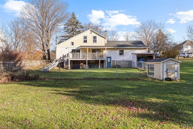 back of property featuring a yard, a shed, and a deck