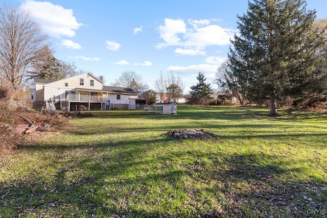 view of yard with a shed and a deck