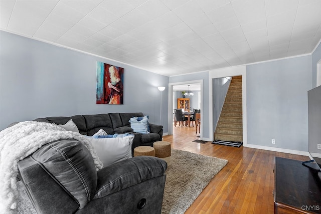 living room with hardwood / wood-style floors and ornamental molding