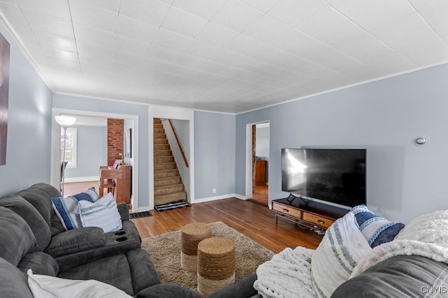 living room with wood-type flooring and ornamental molding