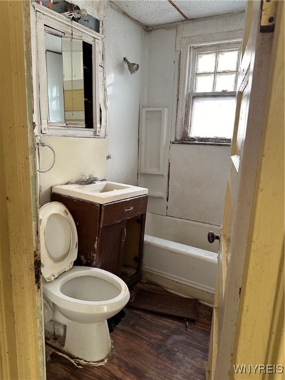 full bathroom featuring bathing tub / shower combination, vanity, wood-type flooring, and toilet