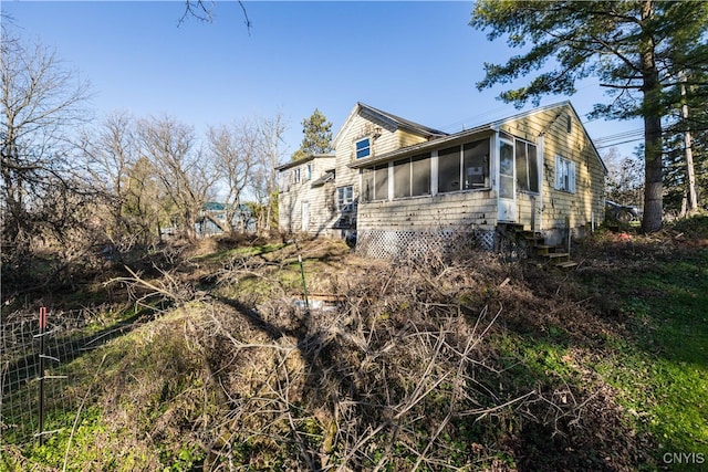 view of side of property featuring a sunroom