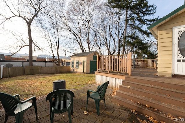 exterior space with a deck and a storage unit