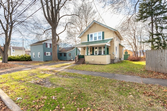 bungalow-style home with a front lawn and a porch