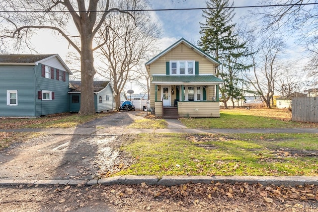 view of front facade with covered porch and a front yard