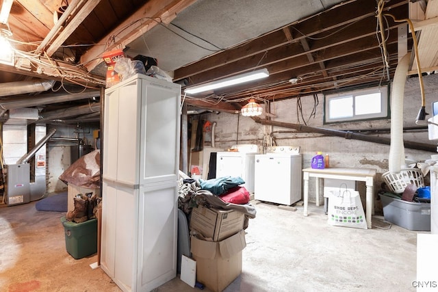 basement featuring washing machine and dryer and heating unit