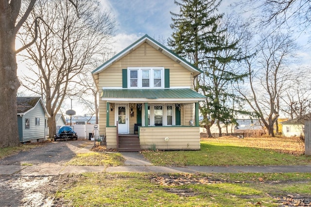 bungalow-style house with covered porch and a front lawn