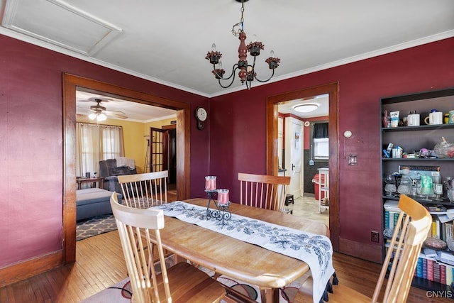 dining room featuring ceiling fan with notable chandelier, light hardwood / wood-style flooring, and crown molding