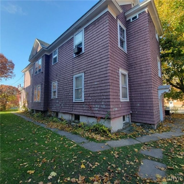 view of home's exterior with a lawn