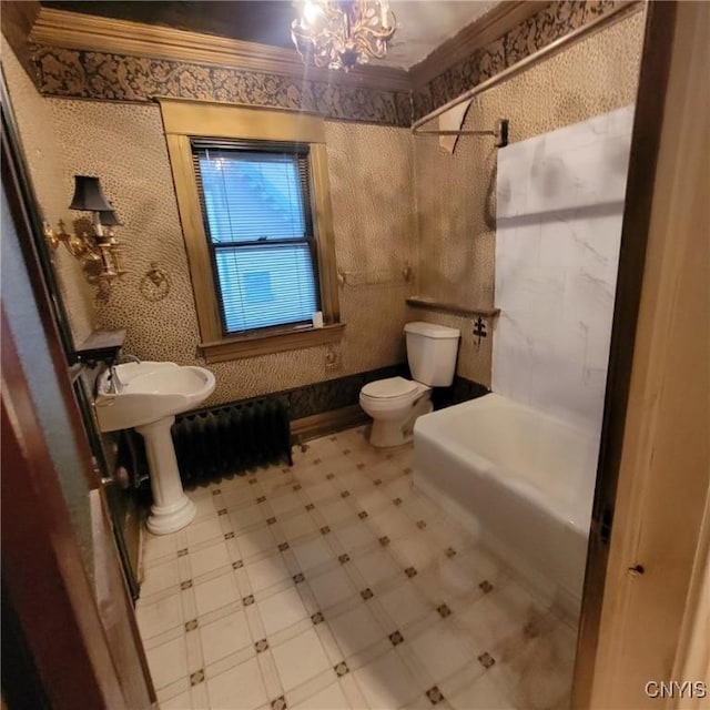 bathroom featuring a chandelier, a bath, toilet, and ornamental molding