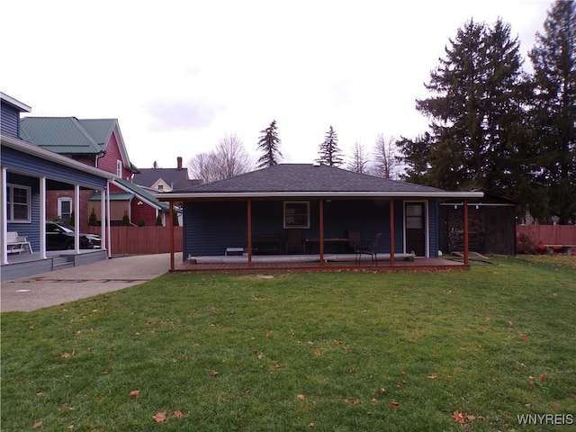 rear view of house with a yard and a patio