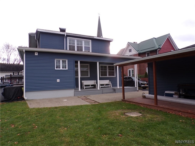 rear view of property featuring a yard