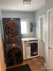 clothes washing area featuring stacked washer / dryer