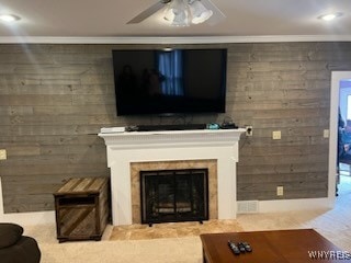 living room with ceiling fan and ornamental molding