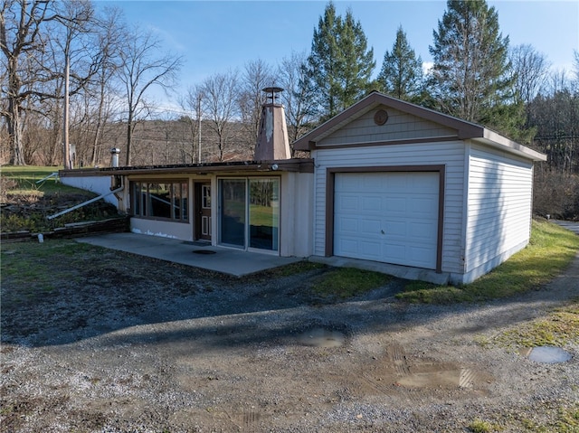 exterior space with a garage and a patio area