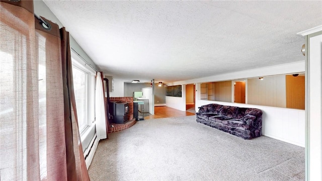 living room featuring carpet flooring, a textured ceiling, and a wealth of natural light