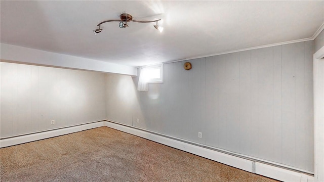 basement featuring baseboard heating and carpet