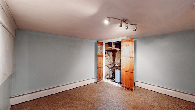 unfurnished bedroom with baseboard heating and carpet floors