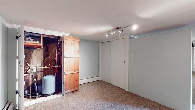 basement featuring carpet floors and a baseboard radiator