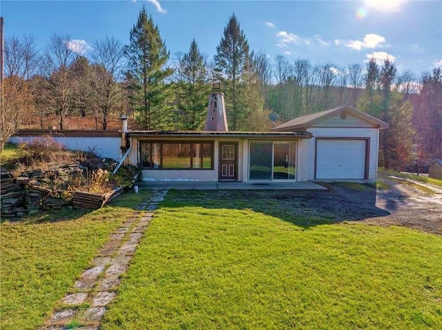 view of front of house with a front yard and a garage