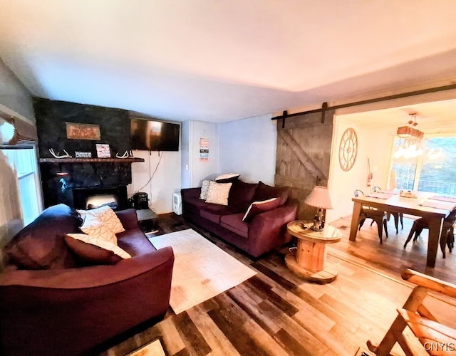 living room featuring a barn door and wood-type flooring