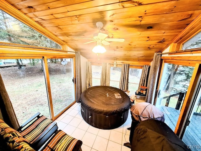 sunroom with ceiling fan, wood ceiling, and vaulted ceiling