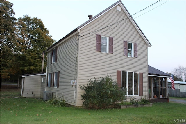 exterior space with a yard, central AC, and a sunroom