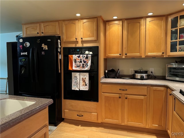 kitchen featuring black appliances and light wood-type flooring