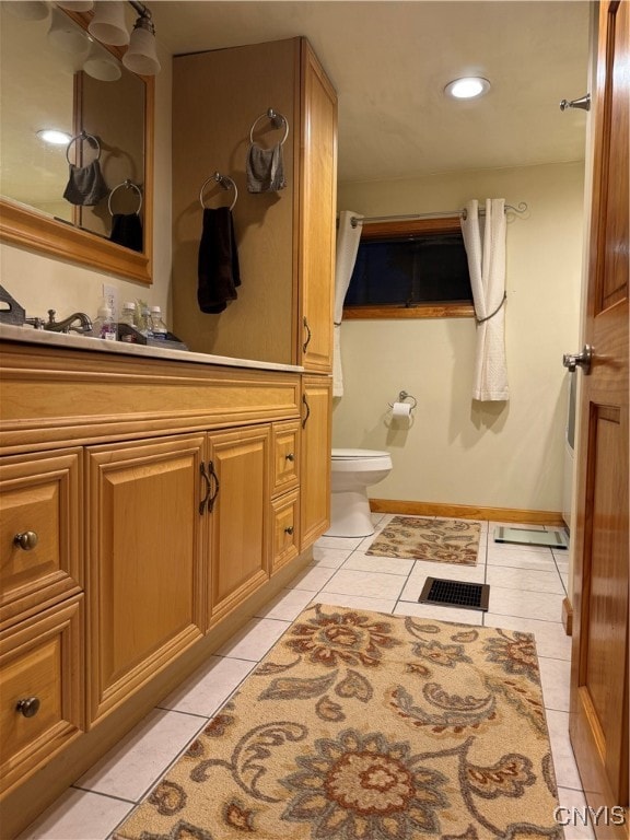 bathroom featuring tile patterned flooring, vanity, and toilet