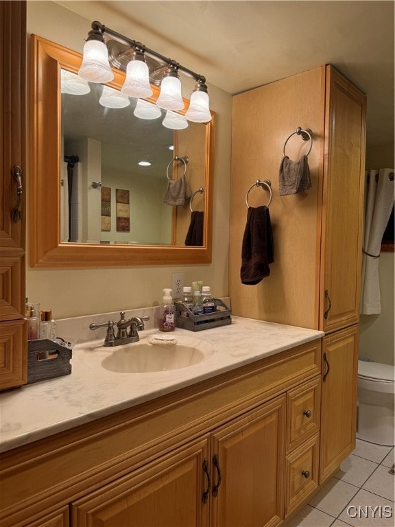 bathroom featuring toilet, vanity, and tile patterned floors