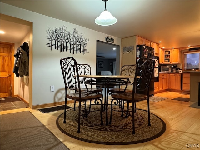 dining area with light wood-type flooring