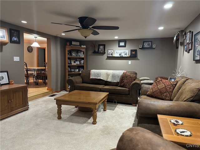 living room featuring ceiling fan and light carpet