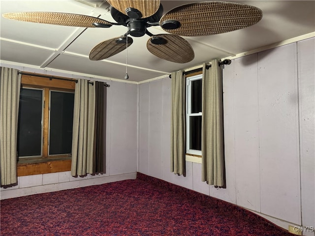 empty room featuring carpet floors and ceiling fan