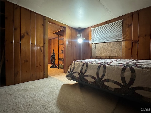 bedroom featuring wood walls and carpet floors