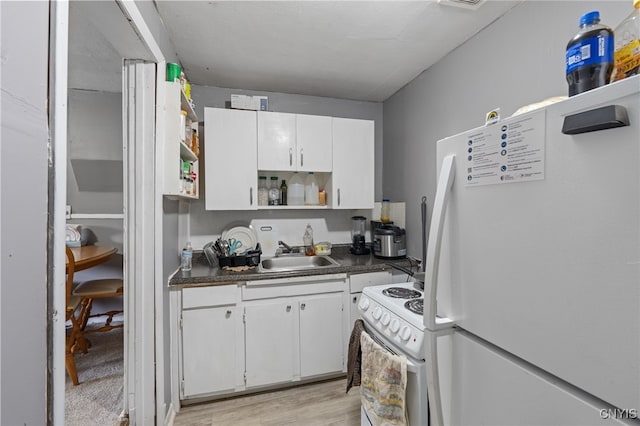 kitchen featuring white appliances, white cabinetry, sink, and light wood-type flooring