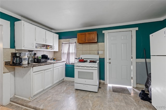 kitchen featuring white cabinets, white appliances, and sink