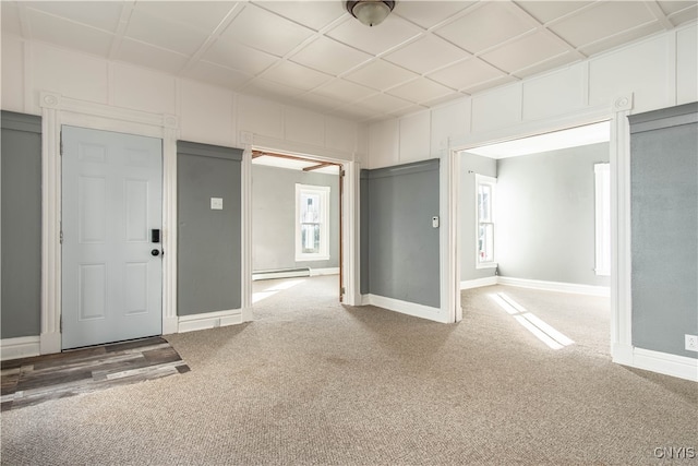 interior space with carpet, a baseboard radiator, and a wealth of natural light