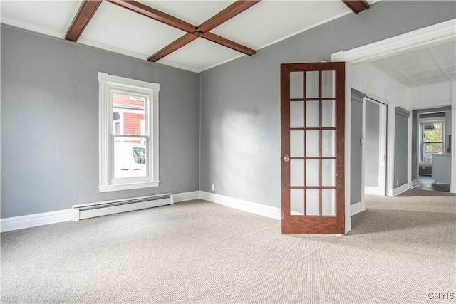 carpeted empty room featuring beamed ceiling, baseboard heating, a healthy amount of sunlight, and coffered ceiling